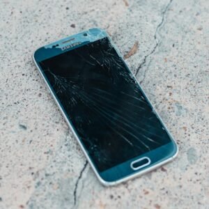black samsung android smartphone on gray concrete floor